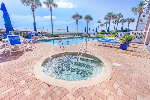 view of pool with a community hot tub and a patio