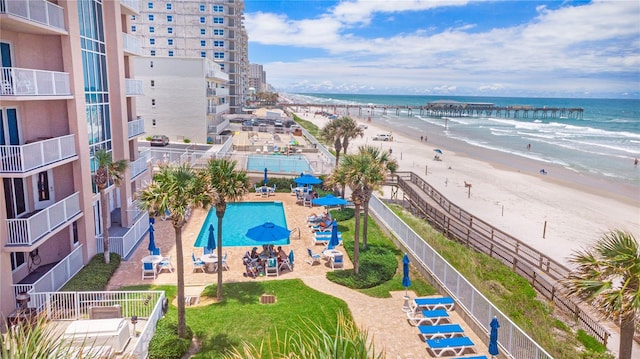 drone / aerial view featuring a water view and a view of the beach