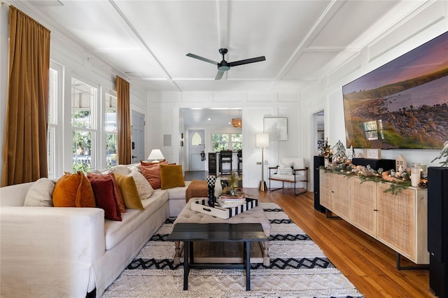 living room with ceiling fan and light hardwood / wood-style flooring