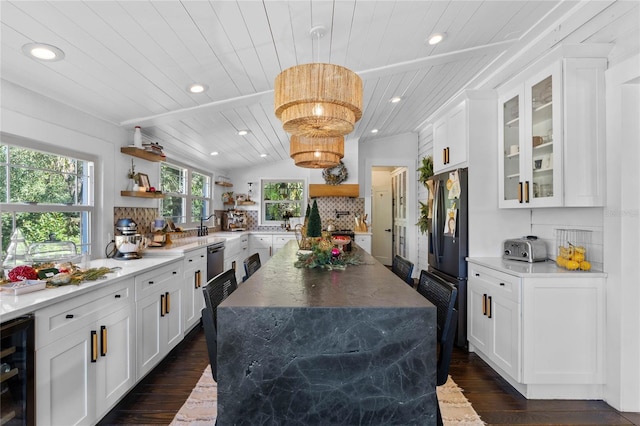 kitchen with tasteful backsplash, hanging light fixtures, wine cooler, and wooden ceiling