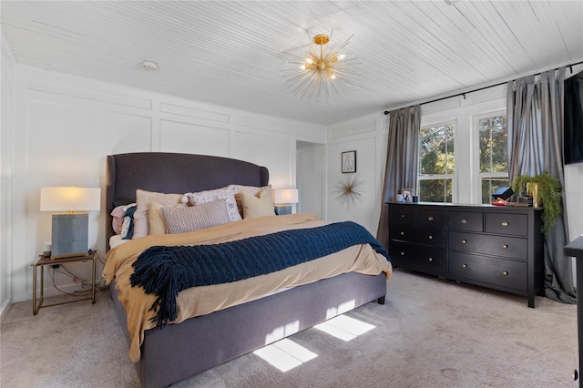 carpeted bedroom featuring a notable chandelier