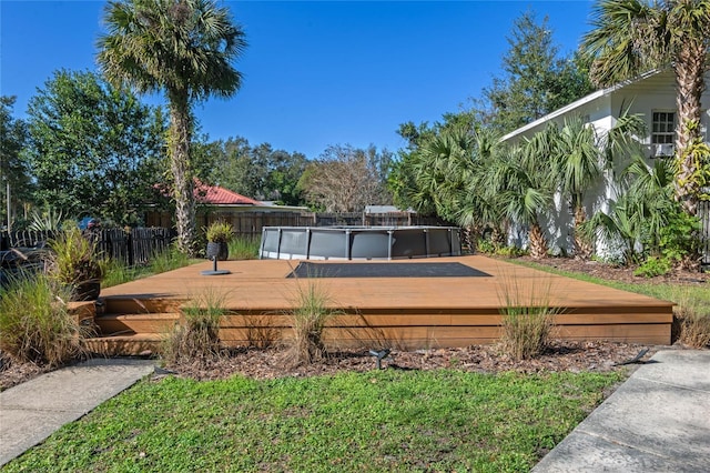 deck featuring a fenced in pool