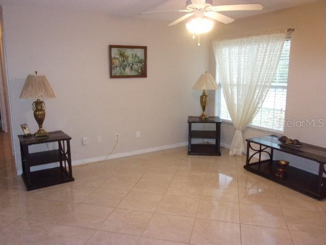 interior space with ceiling fan and light tile patterned flooring