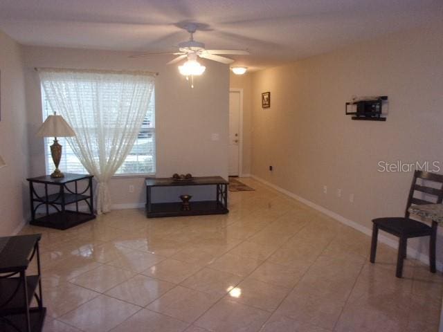 sitting room with ceiling fan and light tile patterned flooring