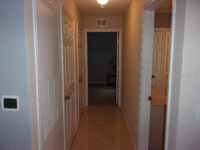 hallway featuring light tile patterned floors