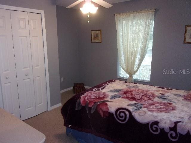 bedroom with ceiling fan and a closet