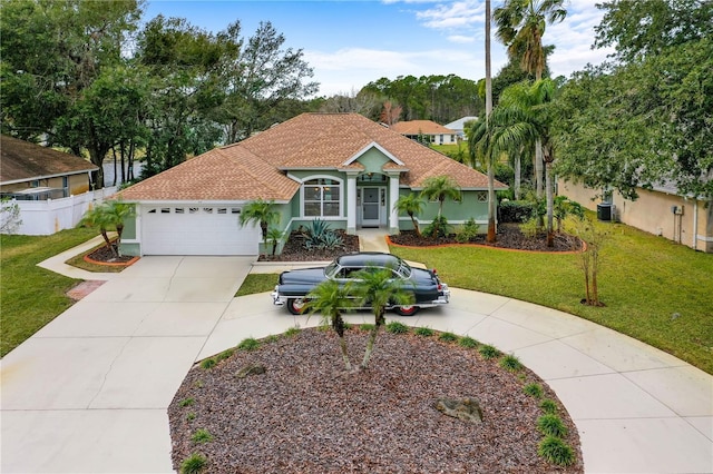 mediterranean / spanish house featuring a garage and a front lawn