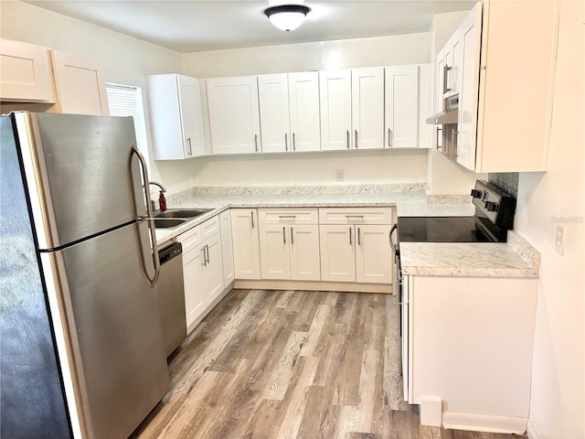 kitchen with sink, white cabinetry, light hardwood / wood-style floors, and appliances with stainless steel finishes