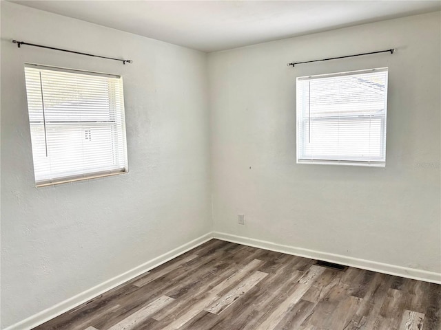 spare room featuring wood-type flooring