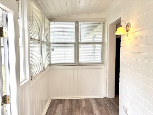 unfurnished sunroom featuring vaulted ceiling