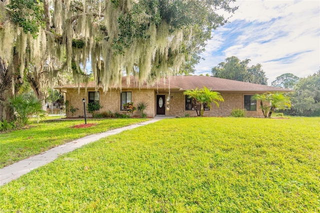 ranch-style house featuring a front lawn