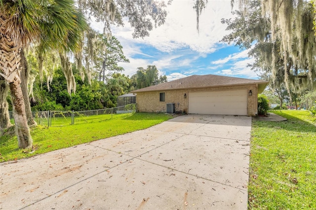 view of property exterior with a yard, central AC, and a garage