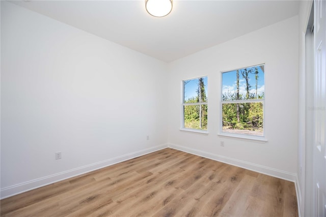 unfurnished room with light wood-type flooring