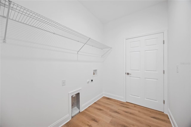 clothes washing area featuring hardwood / wood-style flooring, washer hookup, electric dryer hookup, and hookup for a gas dryer