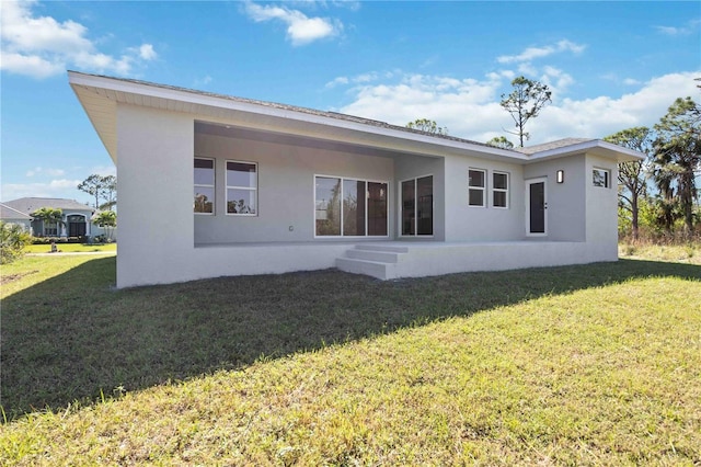 back of property featuring a lawn