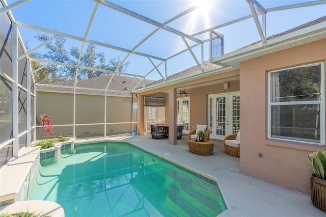 view of swimming pool with ceiling fan, french doors, a patio, and glass enclosure