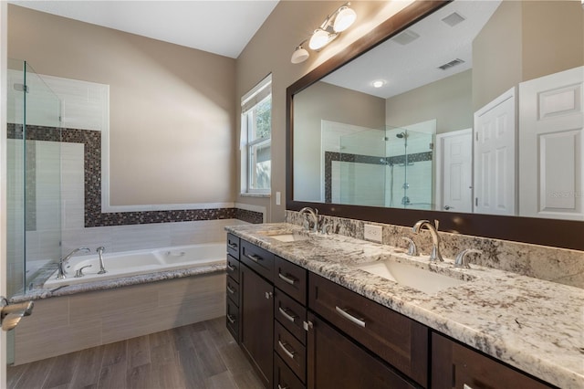 bathroom with wood-type flooring, vanity, and separate shower and tub