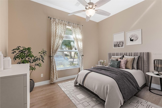 bedroom with ceiling fan and light hardwood / wood-style flooring