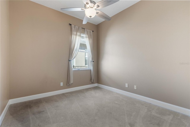 empty room featuring ceiling fan, light carpet, and vaulted ceiling