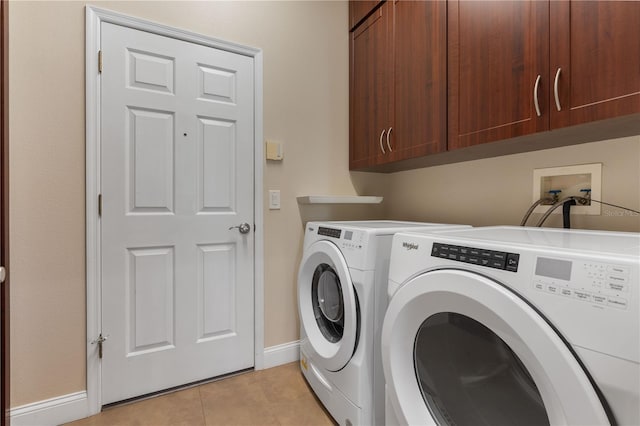 washroom featuring cabinets, light tile patterned floors, and separate washer and dryer