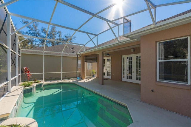 view of pool featuring ceiling fan, french doors, a patio area, and glass enclosure