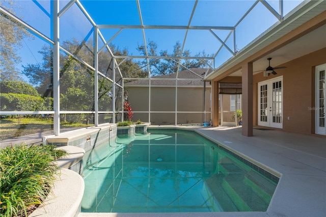 view of pool with ceiling fan, glass enclosure, a patio area, and french doors