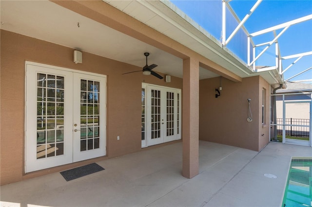 view of patio featuring a lanai, french doors, and ceiling fan