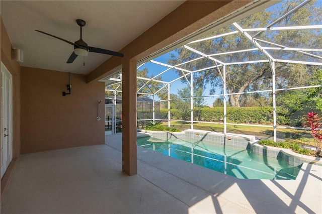 view of pool with a lanai, ceiling fan, and a patio