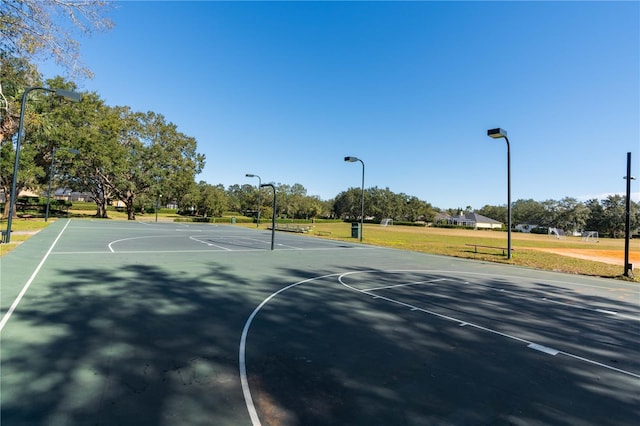 view of sport court featuring a yard