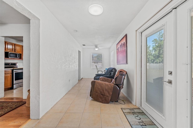 corridor with light tile patterned flooring