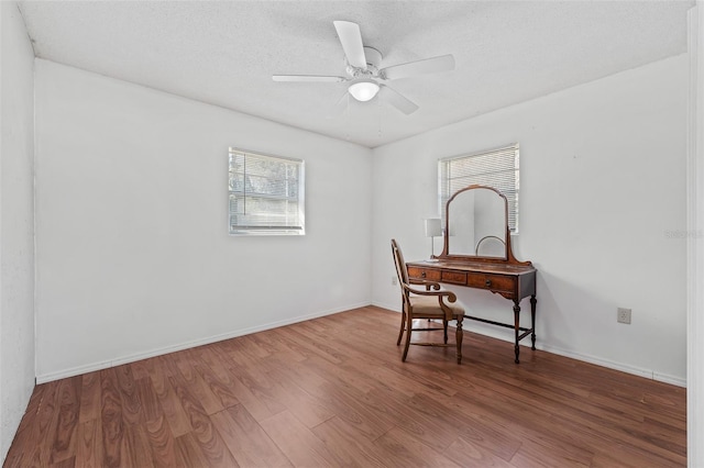 office area with hardwood / wood-style flooring, a textured ceiling, and ceiling fan