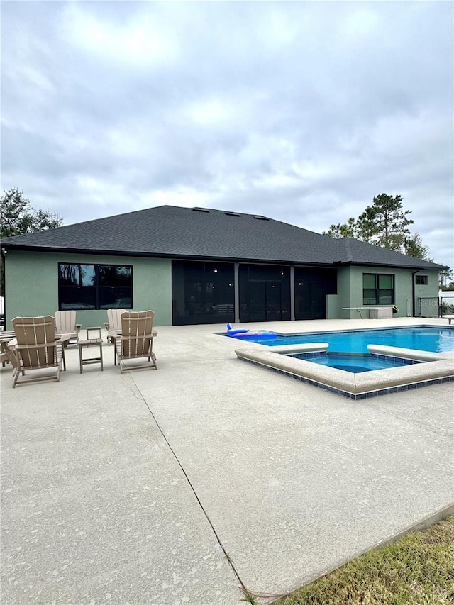 view of pool with a jacuzzi and a patio