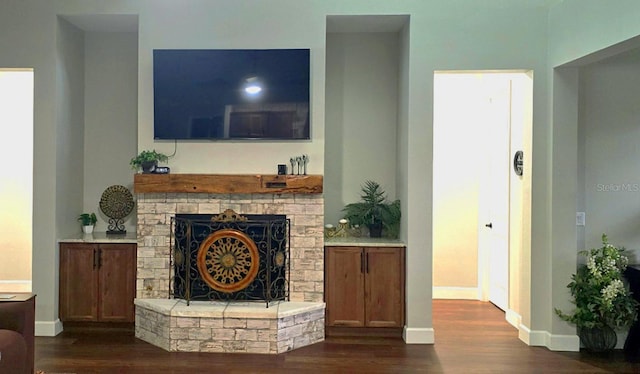 living room featuring dark hardwood / wood-style flooring and a fireplace