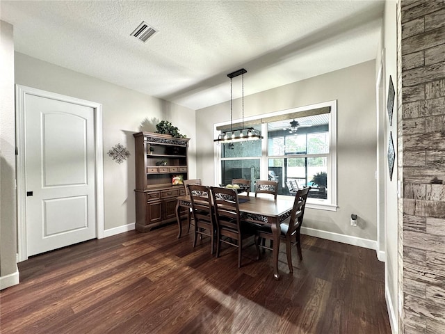 dining room featuring ceiling fan with notable chandelier, a textured ceiling, and dark hardwood / wood-style flooring