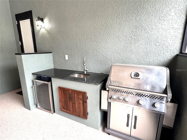 view of patio with sink, beverage cooler, and area for grilling