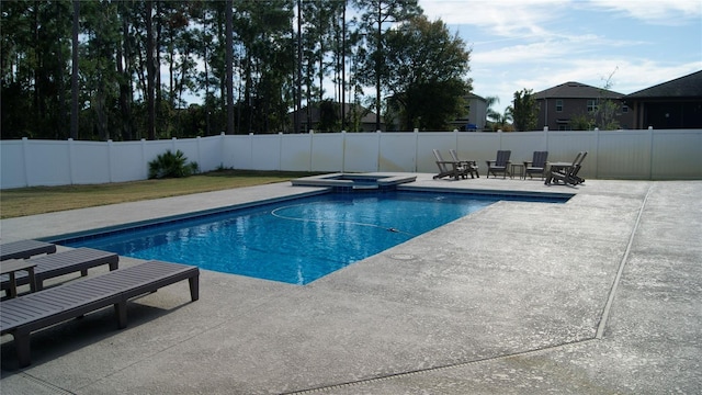 view of pool with an in ground hot tub and a patio area