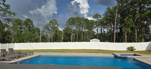 view of swimming pool with an in ground hot tub