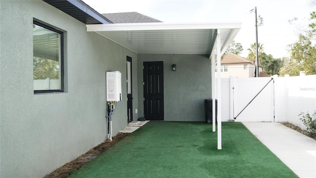 view of exterior entry with a yard