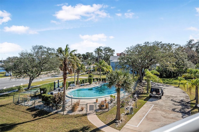 view of pool featuring a yard