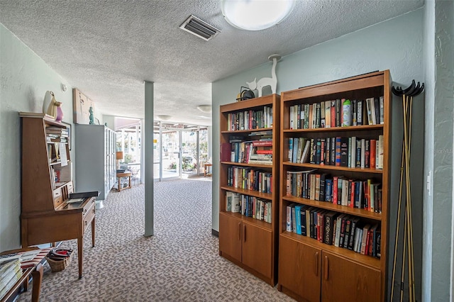 hallway featuring light colored carpet