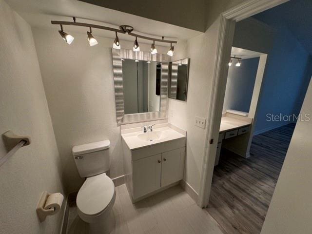 bathroom featuring toilet and vanity