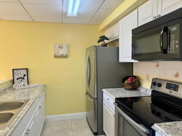 kitchen featuring white cabinetry, tasteful backsplash, and stainless steel range with electric cooktop