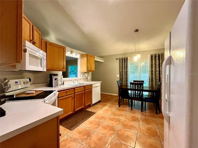 kitchen featuring sink, white appliances, pendant lighting, and light tile patterned flooring