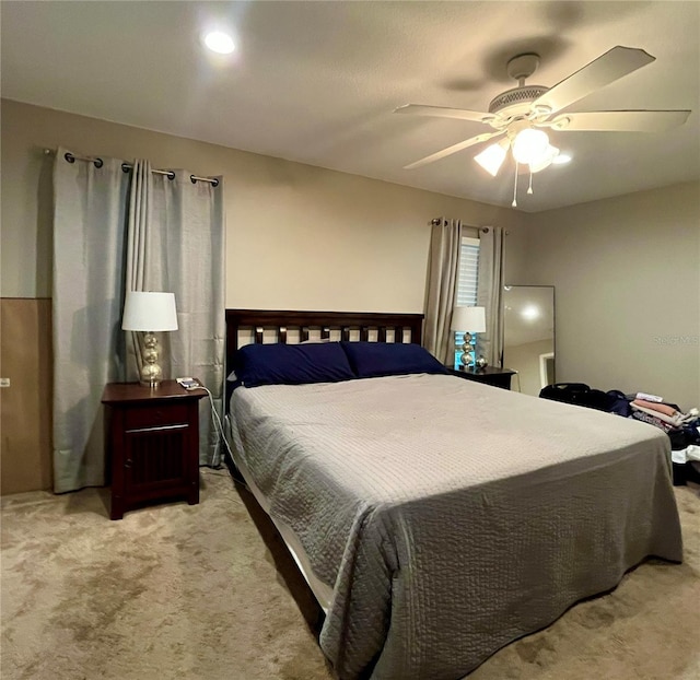 bedroom with light carpet and ceiling fan