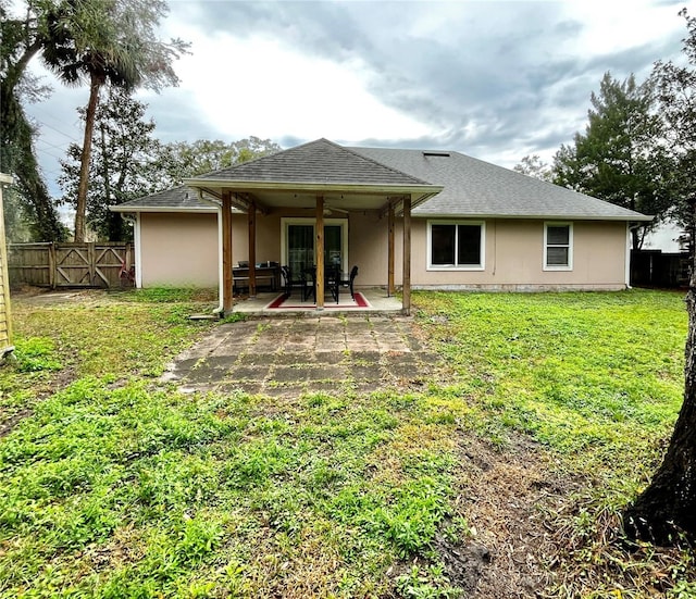 back of house featuring a patio area, a yard, and ceiling fan