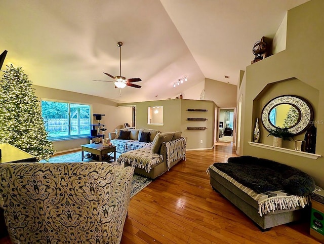 living room featuring hardwood / wood-style flooring, lofted ceiling, and ceiling fan