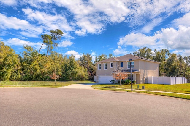 view of front of property with a front yard and a garage