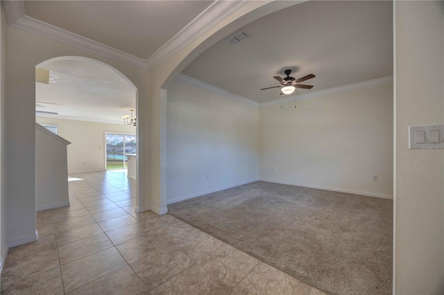 spare room featuring ceiling fan with notable chandelier, light colored carpet, and crown molding