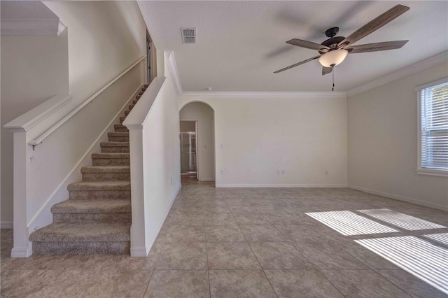 unfurnished room with ceiling fan, crown molding, and light tile patterned flooring