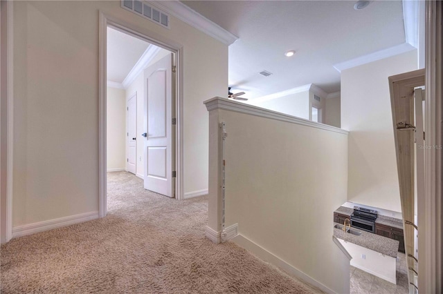 corridor with light carpet and crown molding